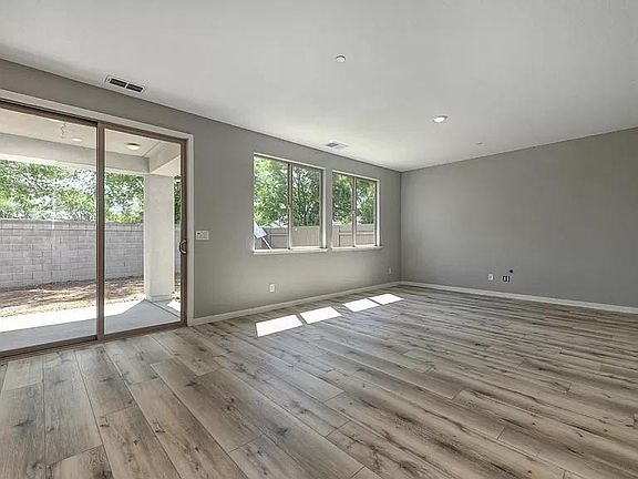 living room, covered patio, fenced backyard