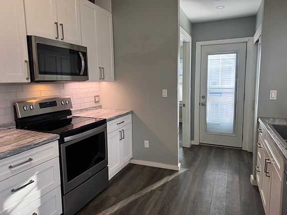 Kitchen towards bedroom and back door