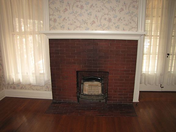 Decorative fireplace and french doors in the dining room.