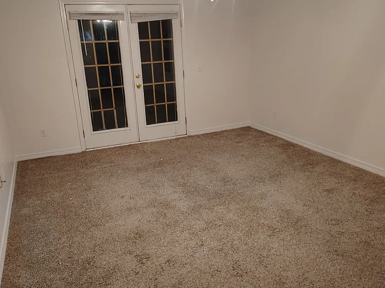 Bedroom #1. French doors to backyard patio.