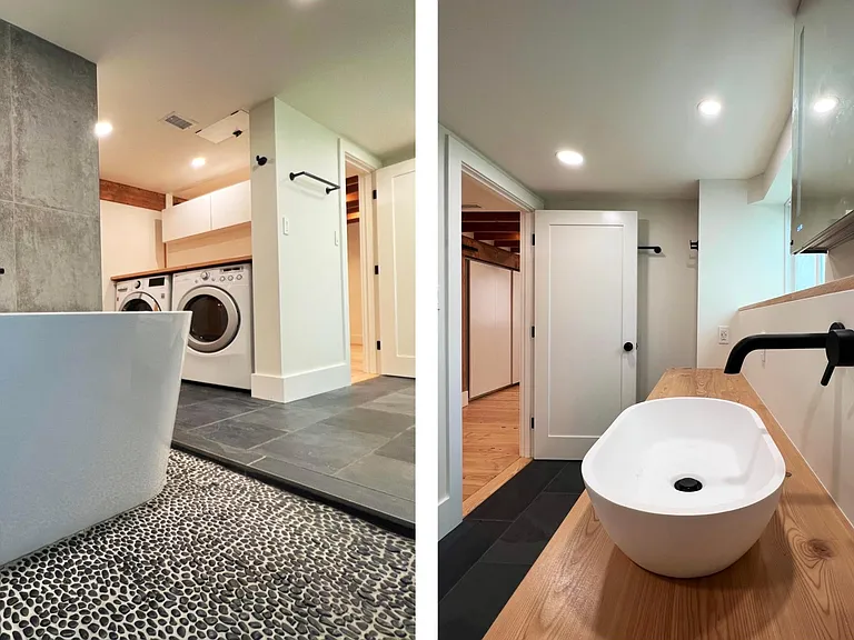 soaking tub in pebble wet area, laundry corner in the background, with laundry shoot connecting the upstairs bathroom _ vessel sink on custom wood cabinet counter