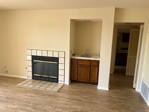 Partial view of living room; wet bar shown..