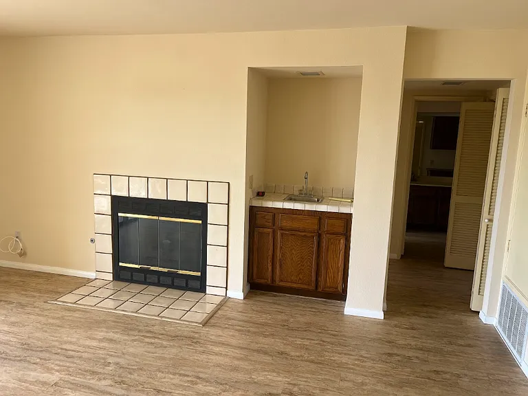 Partial view of living room; wet bar shown..