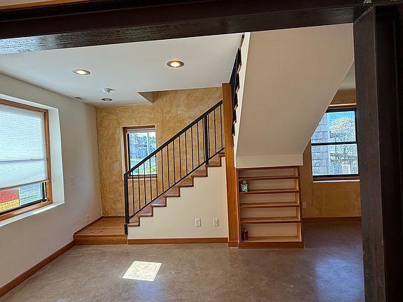 Living room with stairs to second floor with 2 bedrooms and a bath