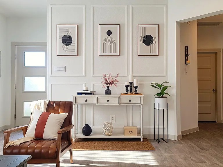 Welcoming entry area with a console table, accent seating, and easy access to adjacent rooms for convenient daily flow.