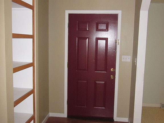 View of front door from just inside (notice built in shelving)