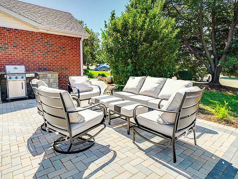 Relax in style with cushioned outdoor seating and a built-in grill, perfect for casual gatherings or quiet afternoons.