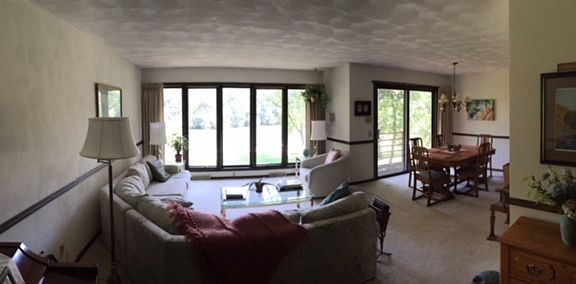 Panoramic of living room : Serene views of the river and wildlife.