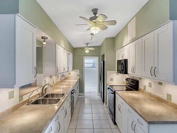 Long view of the kitchen. Plenty of natural light.
