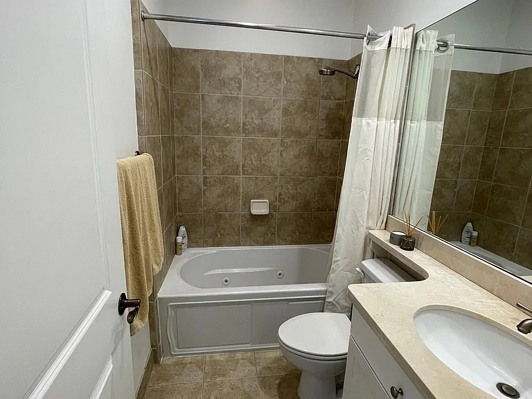 Secondary Full Bath with jacuzzi bath-tub and shower.