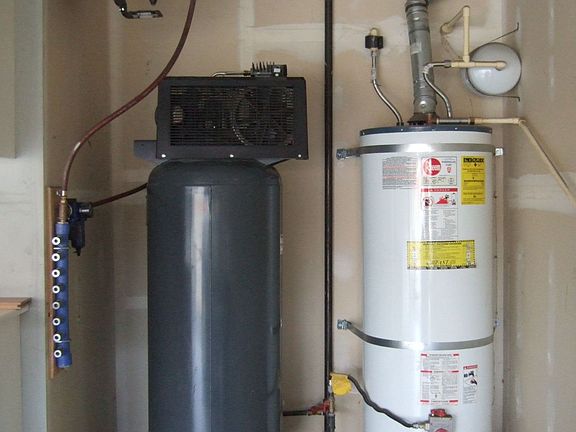 Air compressor and waer heater in garage.