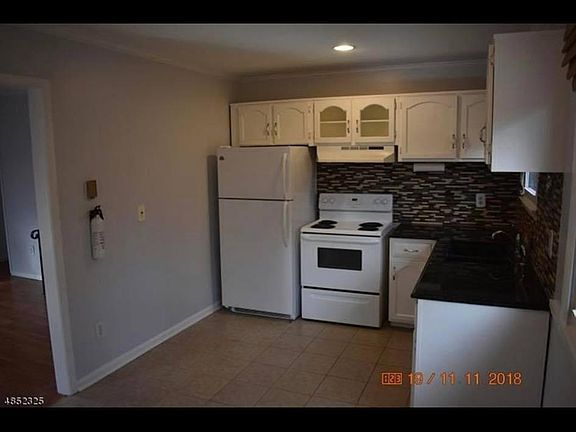 Kitchen with granite countertops and white appliances