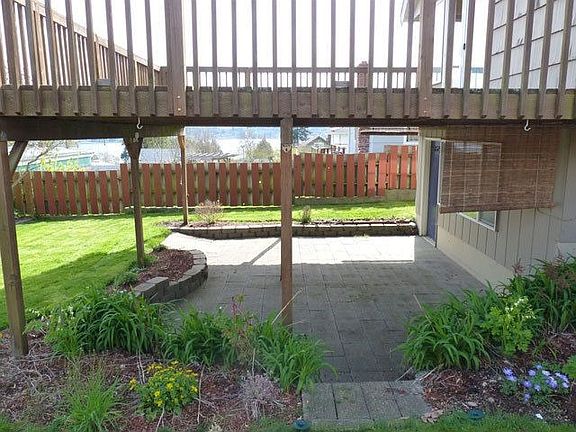 paved, shaded area under deck for relaxation
