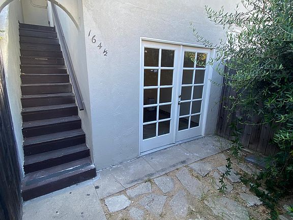 view of garden, bonus room (detached ground floor space - office?) and staircase up to your unit