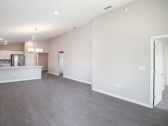 Open gathering room with volume ceiling - Photo showcases the home layout - colors and design optio