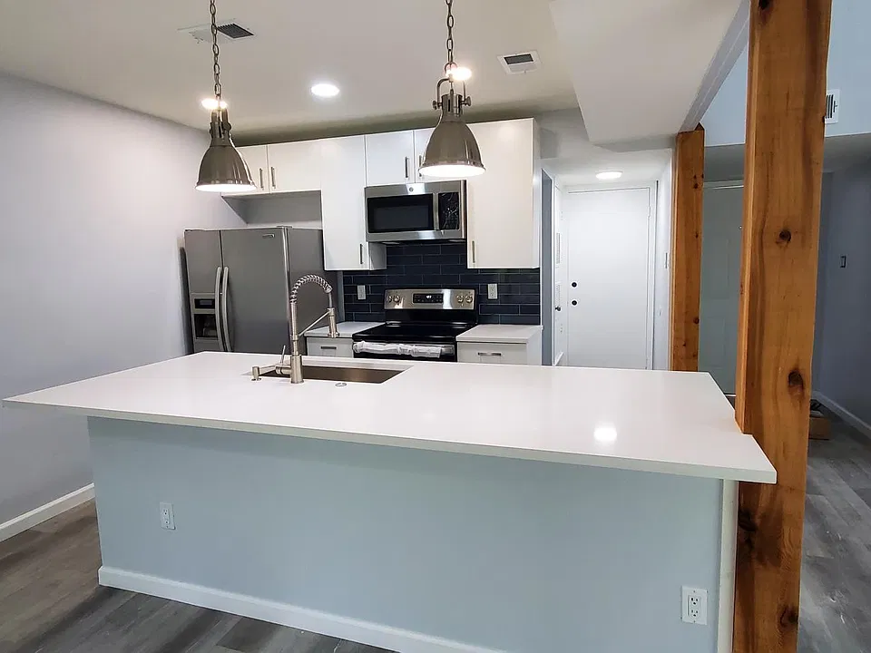 Unit A: Open kitchen with large island! Beautiful deep sink, garbage disposal and plenty of cabinet space!