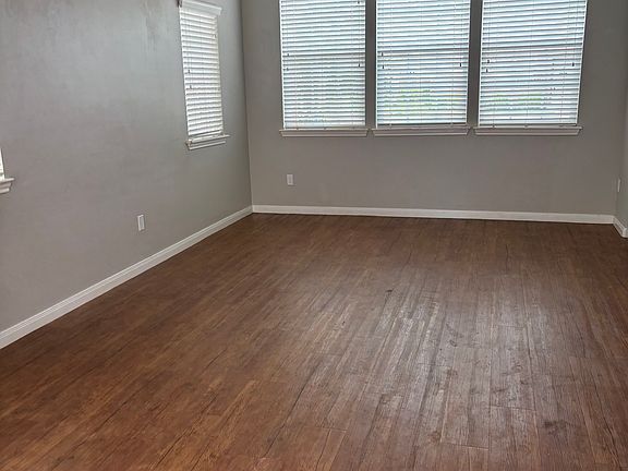 Living room with wood blinds on all windows.