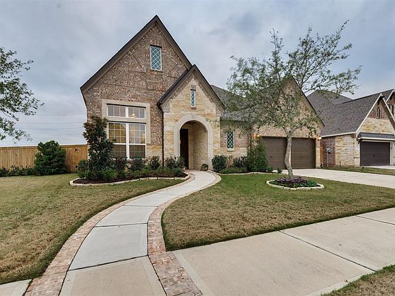 Inviting Curb Appeal this Brick and Stone exterior One Story offers 4 Bedrooms and flexible Extra Rooms.