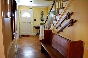 Another view of the front hall with hardwood flrs