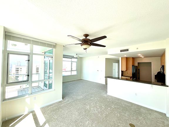 Living/Dining Area has Gas Fireplace, Large Balcony with SW Views (South Bay, Coronado Bridge, Library Dome, Downtown Cityscape, El Cortez Hotel, Central Bay, Spectacular Sunsets, Airport/Runway, Sea World), Several Operable Windows, Ceiling Fan and Light