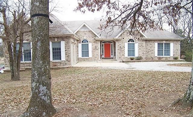 Full Brick front on this custom beauty. Level wooded front yard.