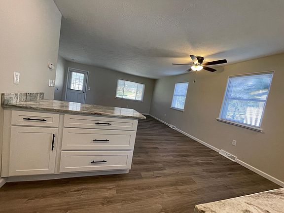 View standing in front of microwave looking to front door. Open Concept.