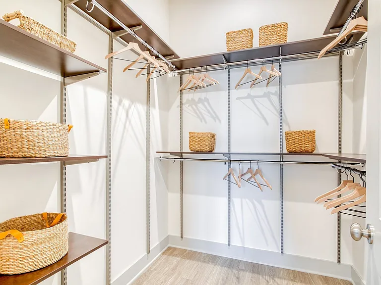 Walk-in closets feature adjustable freedom Rail closet systems.