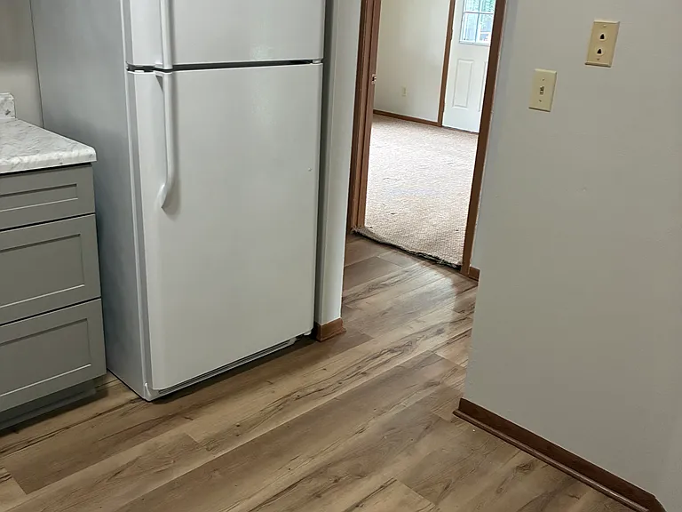 Kitchen view to hallway and primary bedroom