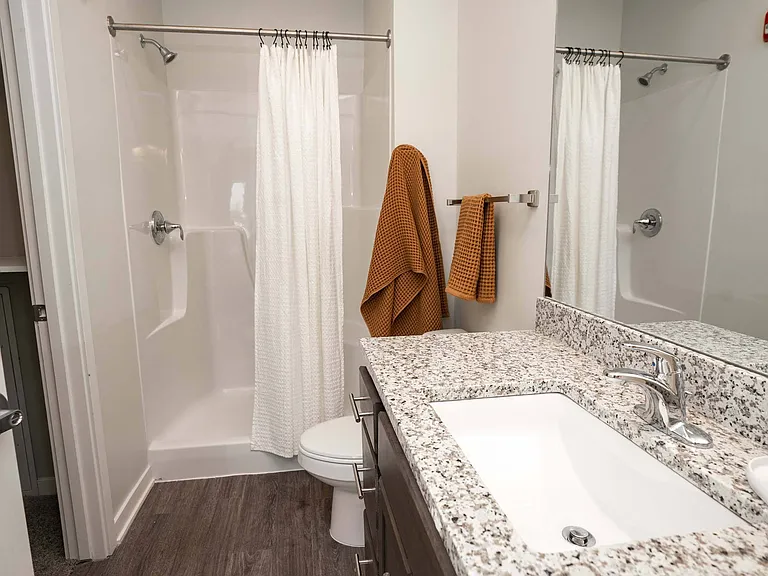 Shower in a large bathroom at Heartland Flats Alliance.