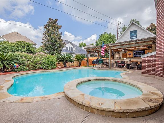Salt water pool/spa and gorgeous landscape make this the perfect retreat. Notice the window above the garage... DON'T FORGET to tour A/C'd the workshop above.