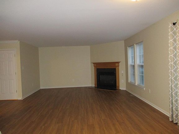 View of Family Room with Gas Fireplace from Kitchen