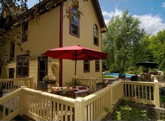 Large deck leads to extensive paver patio and hottub