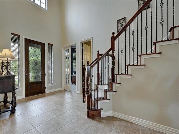 Two-story entry with sweeping staircase.