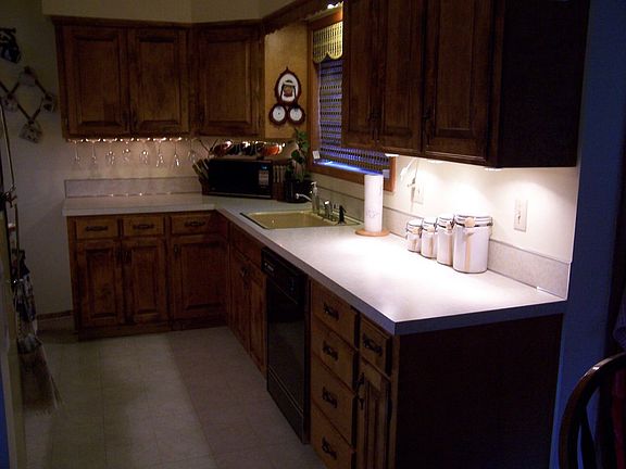 Well laid out kitchen with updated Birch Cabinetry and newer vinyl floor  