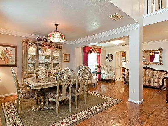 This photo taken from the foyer, illustrates the open floor plan and welcomes you into the formal dining and living areas.