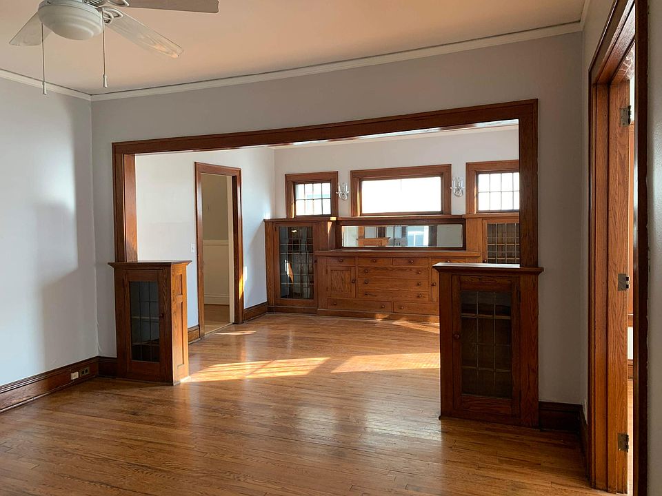 Living room and dining room from front door. Sunroom is to the right. Beautiful oak built-ins with leaded glass doors.
