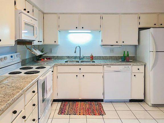 Light and bright kitchen with granite countertops. Fridge to remain.