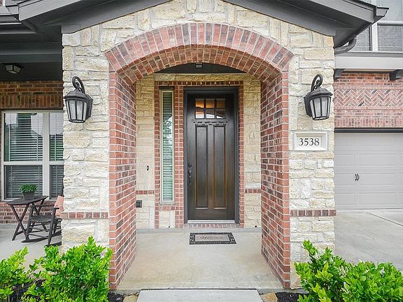 Inviting brick and stone covered entry to greet your guests.