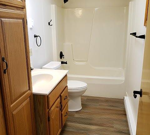 Bathroom with tub/shower combo and comfort height toilet