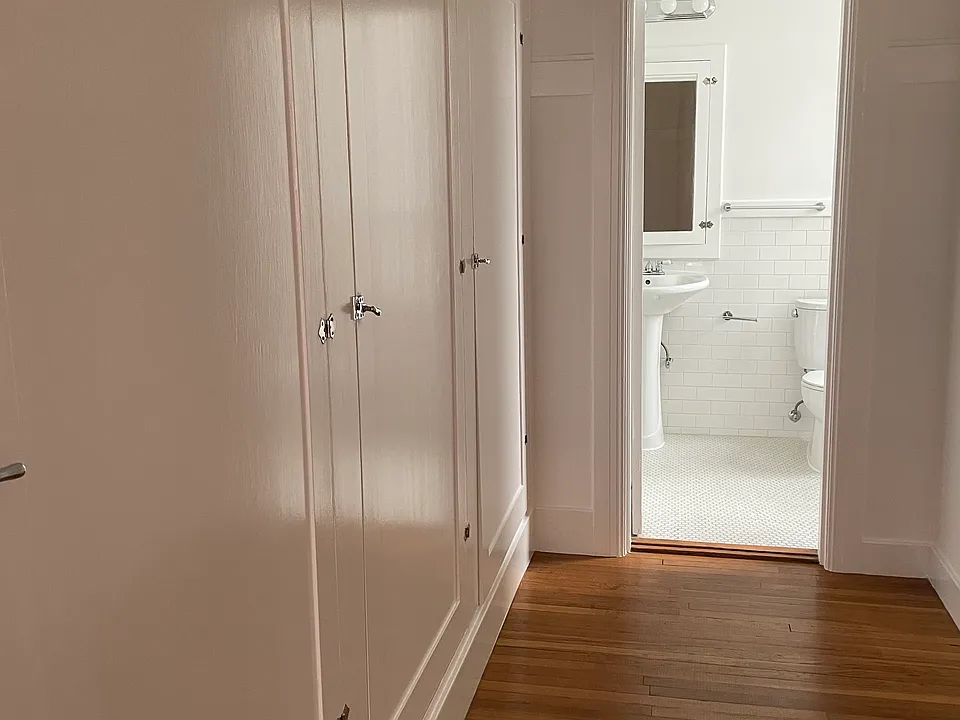 Hall of closets toward bathroom - plenty of room to the right for a desk or dresser and desk