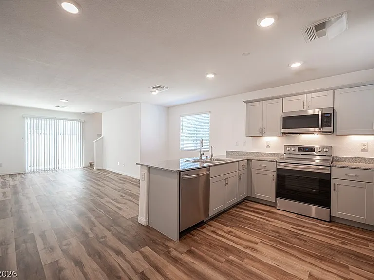 Bright open-plan kitchen and living space with modern finishes and abundant natural light.