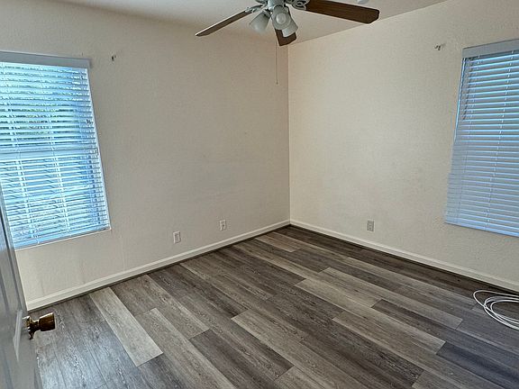 Bedroom with LVP flooring, ceiling fan and closet