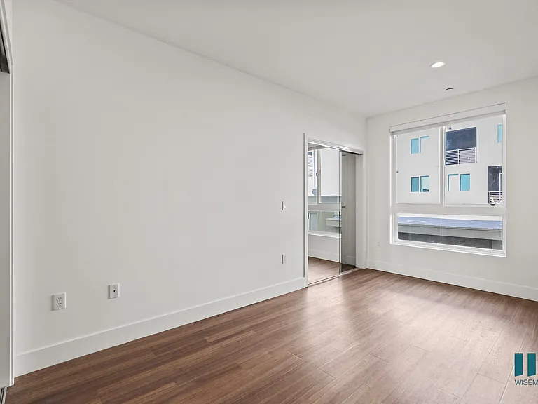 Bedroom with Mirrored Closets and Vinyl Flooring