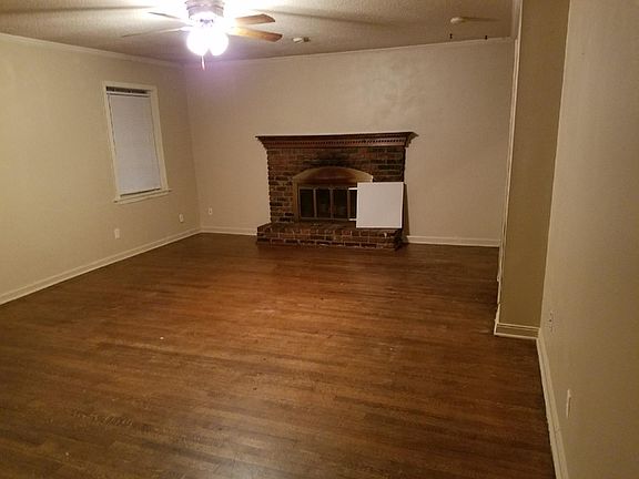 Living room with hardwood floors and fireplace