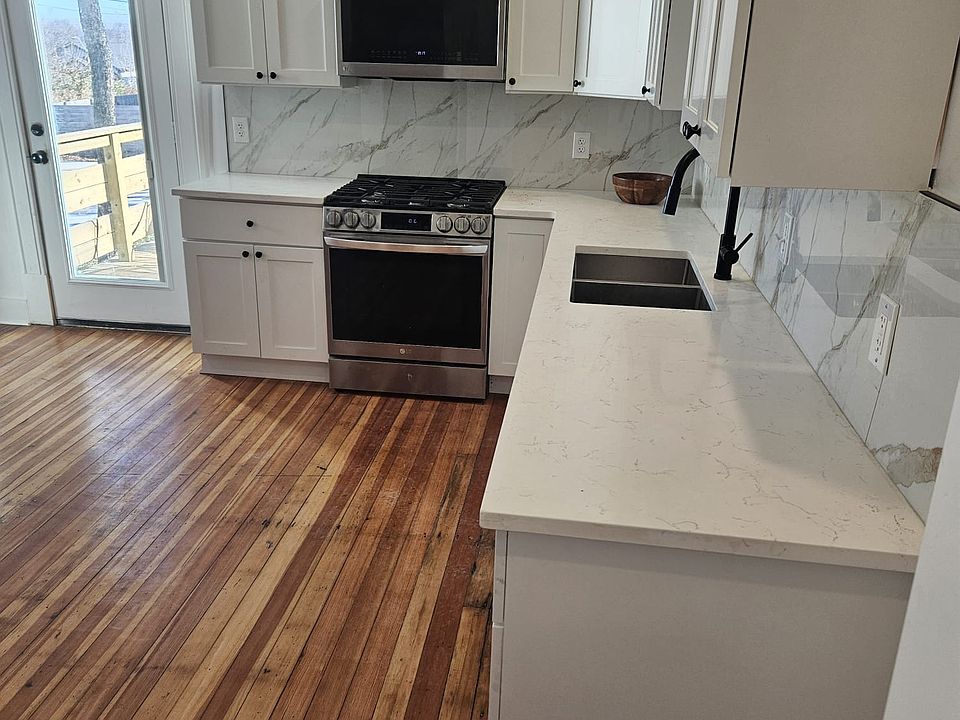 Shared kitchen with stainless steel appliances. Fully stocked