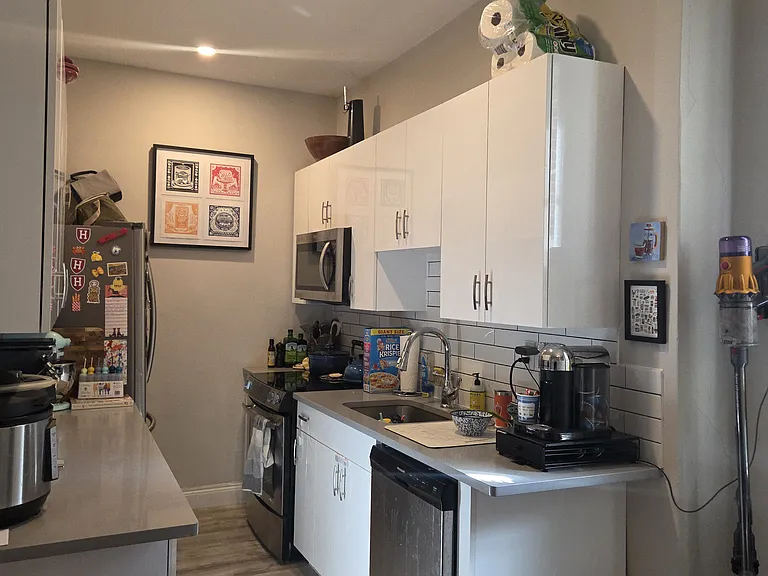 Kitchen with new cabinets, quartz countertops, french door refrigerator, microwave, oven, disposal and dishwasher.