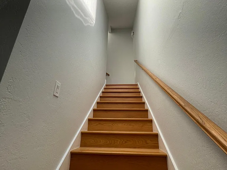 staircase with rail and skylight