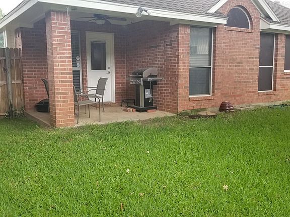 Backyard and Covered Patio with Outdoor Fan