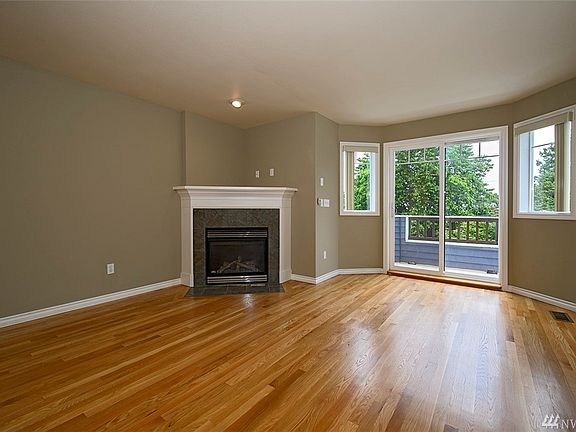 Spacious living rood with hard wood floors.
