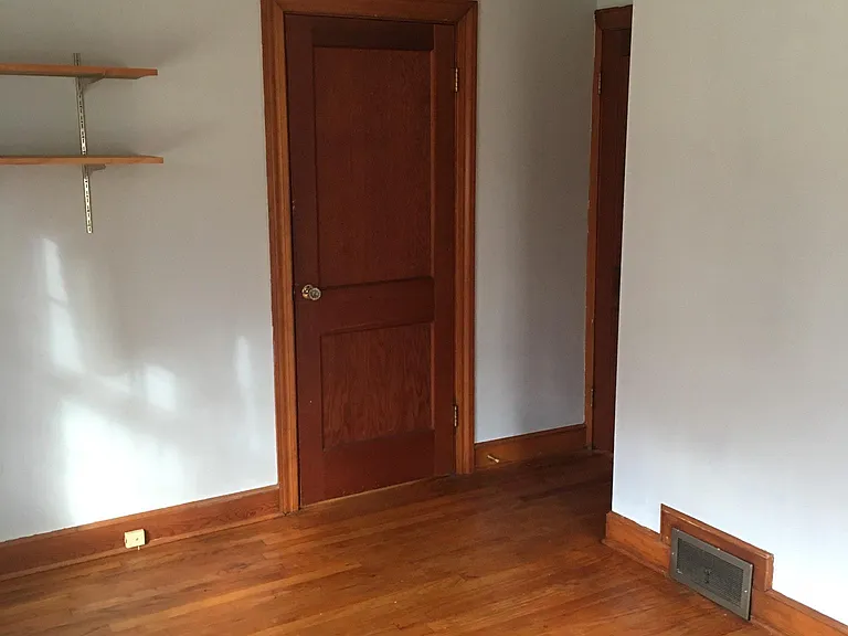 bedroom looking toward doors (there are two -- second in the little alcove that leads to hallway and bathroom)
